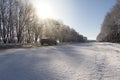 Winter road through snowy fields and forests