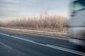 A winter road with a speeding truck Royalty Free Stock Photo