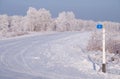 Winter road under snow. The beginning of the road with a zero kilometer sign Royalty Free Stock Photo
