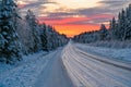 Winter road in Varmland Sweden and orange sunrise