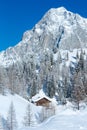 Winter rock with fresh fallen snow on top and house.