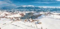 Winter in Romania panoramic view of the Carpathian Mountains and the traditional village Pestera on the Rucar-Bran Pass Royalty Free Stock Photo