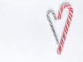 Winter romantic with Christmas lollipops in heart form. Red, green and white spiral stripes.