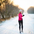 Winter running - Young woman running outdoors Royalty Free Stock Photo