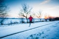 Winter running - Young woman running outdoors Royalty Free Stock Photo