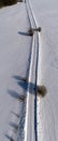 Winter rural gravel road in snow, aerial view