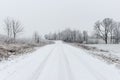 Winter rural scene with fog and white fields Royalty Free Stock Photo