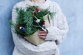 Winter rustic bouquet with fir branches. Female hands holding a Christmas bouquet. New year Royalty Free Stock Photo