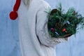 Winter rustic bouquet with fir branches. Female hands holding a Christmas bouquet. New year