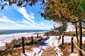 On a winter's day, a boardwalk leads to a pathway through snow-covered dunes along Lake Michigan. Royalty Free Stock Photo