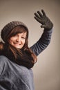 Winter's embrace woman waves, fashionably snug inside Royalty Free Stock Photo