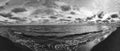 Winter\'s Mystique its ethereal panorama of black and white seascape with ghostly clouds wrapped the sky