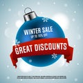 Winter sale. Great discounts. Blue Christmas ball with red ribbon. Royalty Free Stock Photo