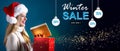 Winter sale message with woman opening a gift box Royalty Free Stock Photo