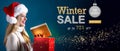 Winter sale message with woman opening a gift box Royalty Free Stock Photo