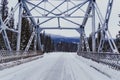 Winter scene of a bridge crossing the Bow River on the snow covered, icy Bow Valley Parkway in Banff National Park Canada Royalty Free Stock Photo