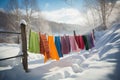 winter scene with colorful clothes drying against white snow