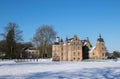 Winter scene with dutch historic architecture. Medieval castle in snow landscape with moat and towers, rural nature. Culture trave Royalty Free Stock Photo