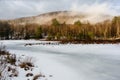 Winter Scene of Fog Lift over Frozen Lake - Adirondack Mountains - New York Royalty Free Stock Photo