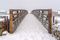 Winter scene with footsprints on the snowy bridge