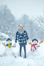 Winter scene with happy people on white snow background. Winter day. Winter woman clothes. Cute snowman at a snowy Royalty Free Stock Photo