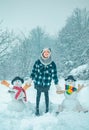 Winter scene with happy people on white snow background. Winter day. Winter woman clothes. Cute snowman at a snowy Royalty Free Stock Photo