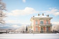 winter scene of an italianate home with a snowcapped belvedere