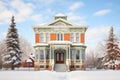 winter scene of an italianate home with a snowcapped belvedere