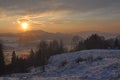 Winter scene with mountains, trees, sunset and snow