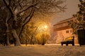 Urban residential house building, street light, park bench, garbage can, snow laden trees - Bucharest, Romania Royalty Free Stock Photo
