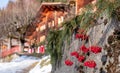 Winter scene photographed in the Alps outside the village of Wengen in Switzerland. Wood chalet, with red berries in foreground. Royalty Free Stock Photo