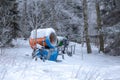 Winter scene in a rest zone near a forest. Benches and snowmen, forest road