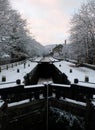 Winter scene on the rochdale canal in hebden bridge with snow covered towpath and houses Royalty Free Stock Photo