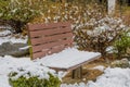 Wooden park bench covered with snow Royalty Free Stock Photo