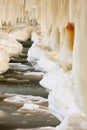 Winter scenery. Baltic Sea. Close up ice formations icicles on pier poles Royalty Free Stock Photo