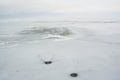 Winter scenery with cracked ice on frozen lake Royalty Free Stock Photo