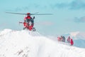 A rescue helicopter landing in the alpine snow Royalty Free Stock Photo