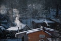 winter scenery with smoke coming from house chimneys