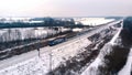 Winter scenery. Train dashing through the snow covered railroad. aerial view Royalty Free Stock Photo