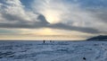 Winter sea sunset. Panoramic view of the snow-covered shore of the frozen sea, the lake at sunset. Shards of ice close-up. Royalty Free Stock Photo