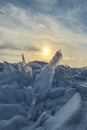 Winter sea sunset. Panoramic view of the snow-covered shore of the frozen sea, the lake at sunset. Shards of ice close-up. Royalty Free Stock Photo