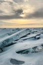 Winter sea sunset. Panoramic view of the snow-covered shore of the frozen sea, the lake at sunset. Shards of ice close-up. Royalty Free Stock Photo