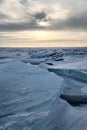 Winter sea sunset. Panoramic view of the snow-covered shore of the frozen sea, the lake at sunset. Shards of ice close-up. Royalty Free Stock Photo