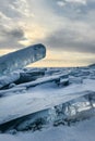 Winter sea sunset. Panoramic view of the snow-covered shore of the frozen sea, the lake at sunset. Shards of ice close-up. Royalty Free Stock Photo
