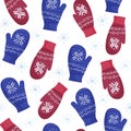 Winter seamless pattern of cozy knitted mittens of blue and red color with ornament. Warm clothes to protect hands from cold in wi Royalty Free Stock Photo