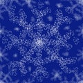 Winter seamless pattern of white lace snowflakes on a blue background. Royalty Free Stock Photo