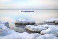 Winter seascape, slow freezing sea, glorious skies, white pieces of ice