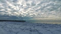 Seascape, slow freezing sea, glorious skies, white pieces of ice by the sea