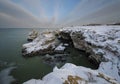 Winter Seascape at sunrise of rocky, frozen coast Royalty Free Stock Photo