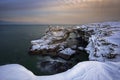 Winter Seascape at sunrise of rocky, frozen coast Royalty Free Stock Photo